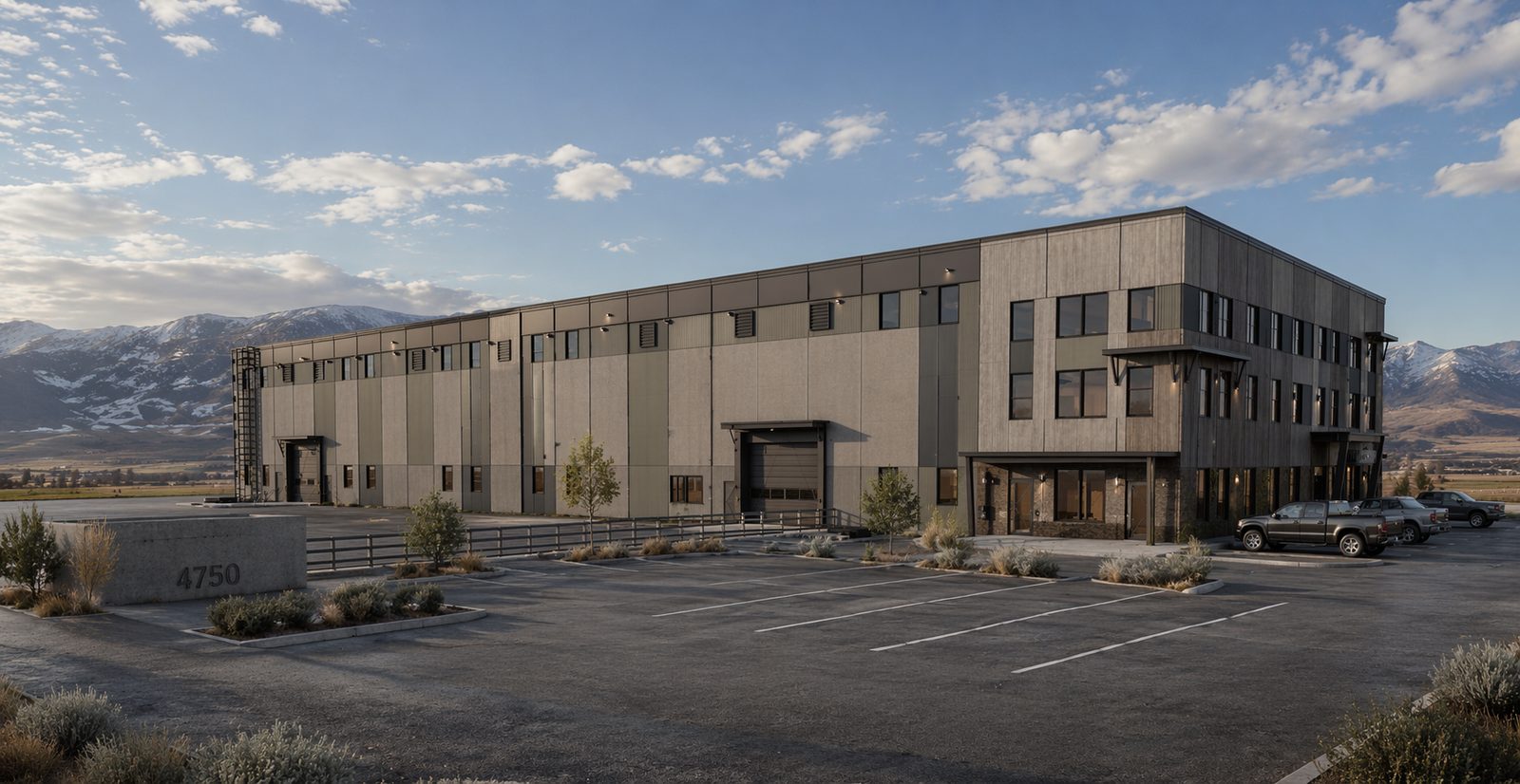 Photoreal render of a two-story commercial building at dusk with mountains behind